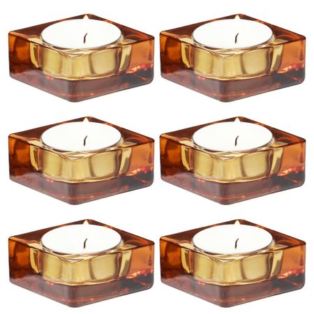 set of four square candle holders with candles in each one, gold and brown glass