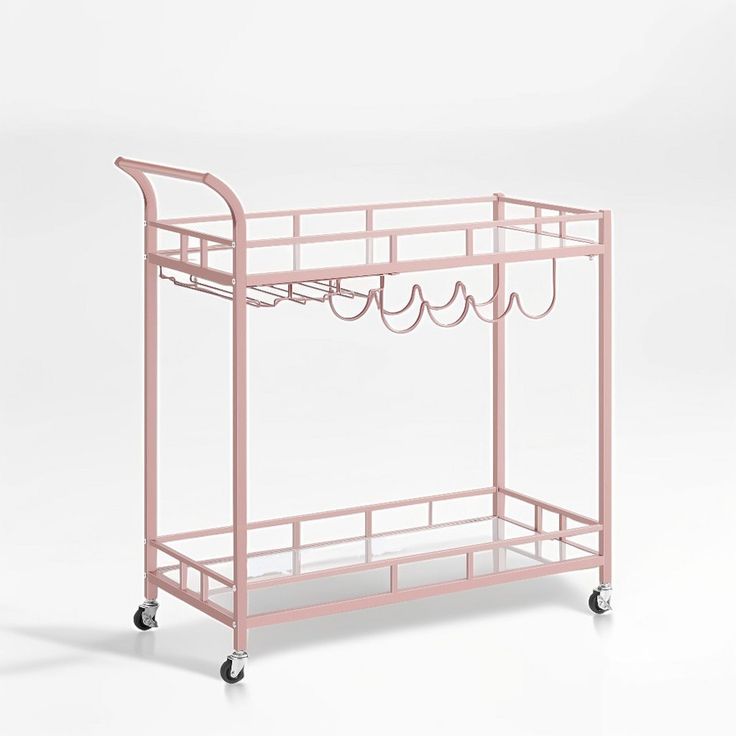 a pink metal cart with wire on the top and bottom shelves, holding several items