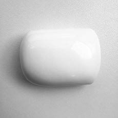 a white wall mounted soap dispenser