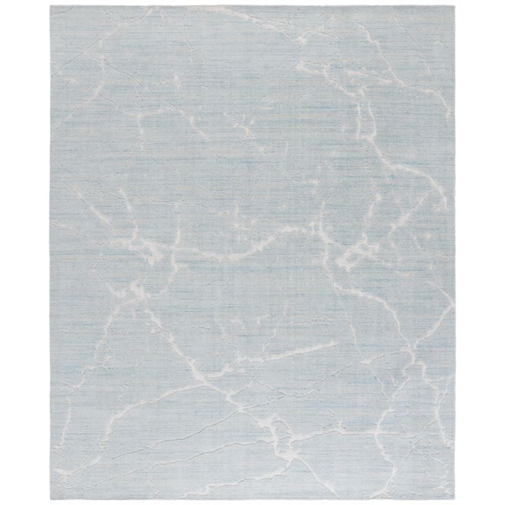 a blue and white rug with an abstract design