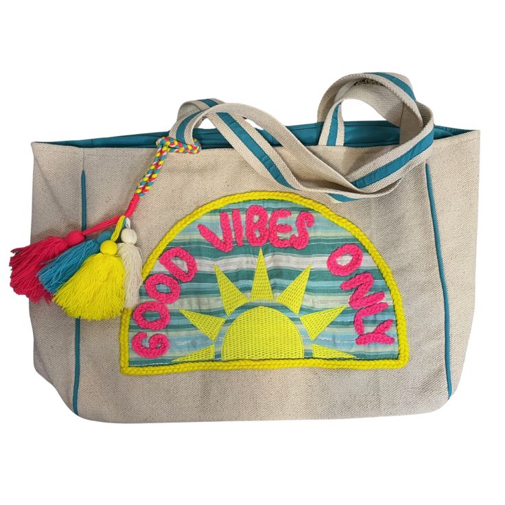 Carry your beach, pool, or lake essentials in style with this "Good Vibes Only" tote bag. Embroidered yarn detail and fun, bright colors add a playful touch to any beach day. Spread positive vibes wherever you go - only good vibes allowed! 21” x 15.5” Sunshine Patch Beach Tote Snap Closure Fun Decorative Tassels Canvas fabric Over the shoulder straps Interior Pockets Trendy Green Canvas Beach Bag, Trendy Summer Beach Bag For Weekends, Casual Embroidered Tote Beach Bag, Bohemian Beach Bag Made Of Canvas, Multicolor Rectangular Bag For Poolside, Fun White Beach Bag For Vacation, Embroidered Travel Bags For Beach Season, Embroidered Tote Shoulder Bag For Beach, Blue Canvas Beach Bag