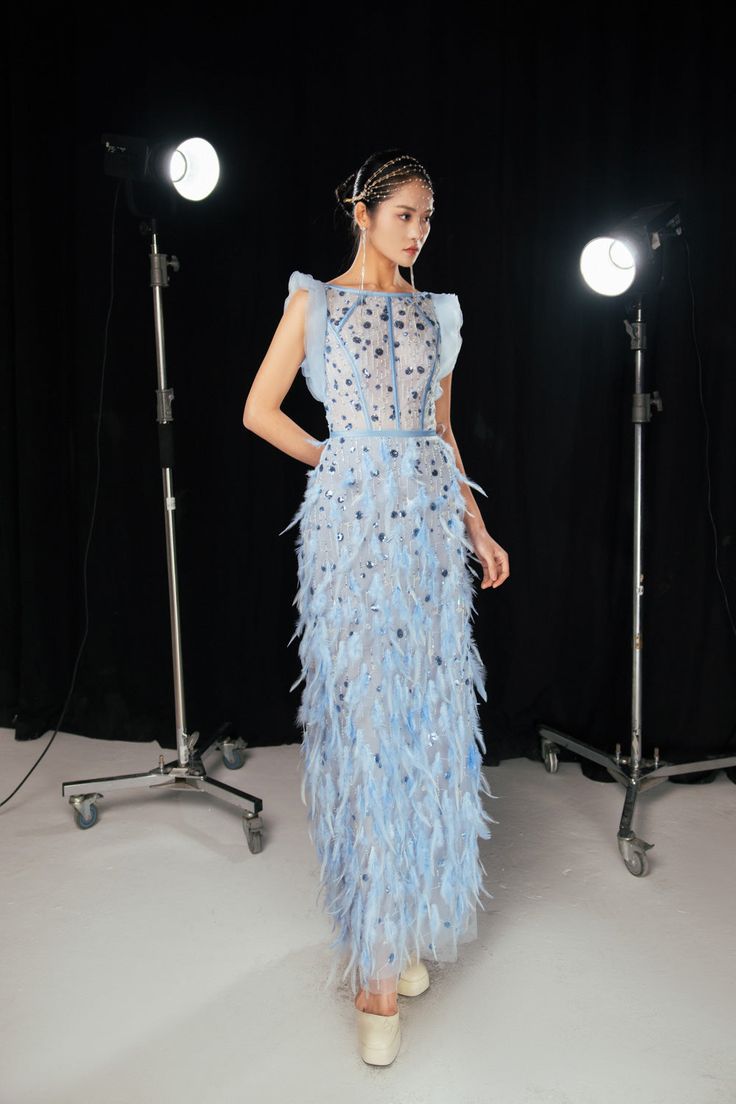 Crafted with delicate feathers and graceful twill, this dress exudes elegance and sophistication. Its sheath silhouette and floor length design will make you feel like a work of art. Elevate your wardrobe with this exclusive dress. *Note: Product color is varied due to studio lighting. Evening Floor-length Gown With Feathers, Formal Floor-length Feathered Gown, Floor-length Feather Trim Evening Dress, Floor-length Evening Dress With Feather Trim, Evening Gown With Feathers Floor-length, Feathered Floor-length Evening Dress, Feathered Floor-length Prom Dress, Sleeveless Feathered Evening Dress For Gala, Floor-length Feathered Gown For Gala