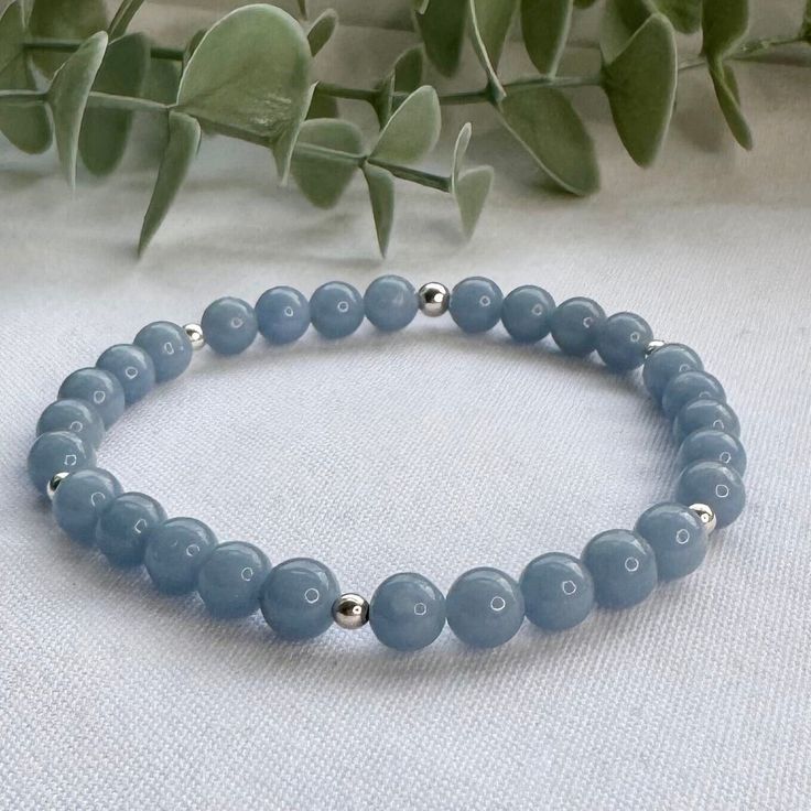 A beautiful handmade Angelite beaded bracelet. This stretch bracelet is perfect for crystal healing, an energy beaded bracelet featuring genuine, ethically sourced 6mm Angelite gemstone beads and your choice of 925 Sterling Silver or 14k Gold Filled accent beads. This minimalist gemstone bracelet is designed and handmade in the UK and can be worn solo for a subtle look or stacked with others to create a unique, custom bracelet stack. This pale blue gemstone bracelet is unisex so is the perfect g Minimalist Gemstone Beaded Bracelets For Meditation, Everyday Blue Gemstone Beads Stretch Bracelet, Everyday Blue Stretch Bracelet With Gemstone Beads, Minimalist Beaded Bracelets For Healing, Minimalist Round Beaded Bracelets For Healing, Minimalist Gemstone Beaded Bracelets For Healing, Minimalist Round Beads Crystal Bracelet For Healing, Minimalist Crystal Bracelet With Round Beads For Healing, Minimalist Bracelets With 8mm Beads For Healing