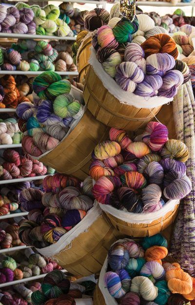 several buckets filled with yarn sitting next to each other