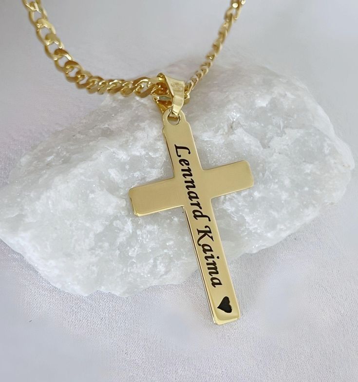 Our engraved gold Crosses are available with a range of chain lengths and different style. Our Gold Crosses have won praise from customers around the world. Check out our customer reviews. ITEM DETAILS: - 14 k gold over Sterling silver Cross. - 14 k gold filled and gold over sterling silver chains to be chosen from drop down menu. Need charms? http://etsy.me/1Njb7NM Classic Crosses  http://etsy.me/1JZ3tah Celtic Crosses  http://etsy.me/1Le9a5C Browse shop: https://www.MCACrossesJewelry.etsy.com It will be sent in a small gift box, silver or white. Chain drop down: Top chain Gold filled rolo    Middle chain Gold filled cable   Bottom chain Gold filled rope    Thank you very much for visiting our store. Cross-shaped Name Jewelry For Anniversary, Name-engraved Cross Jewelry For Anniversary, Anniversary Jewelry With Name And Cross Shape, Cross Pendant Jewelry With Name For Gift, Name Engraved Cross Pendant Jewelry For Gift, Name-engraved Cross Pendant Jewelry Gift, Name Engraved Cross Pendant Jewelry Gift, Name Necklace With Cross Pendant For Gift, Personalized Cross Pendant Jewelry Gift