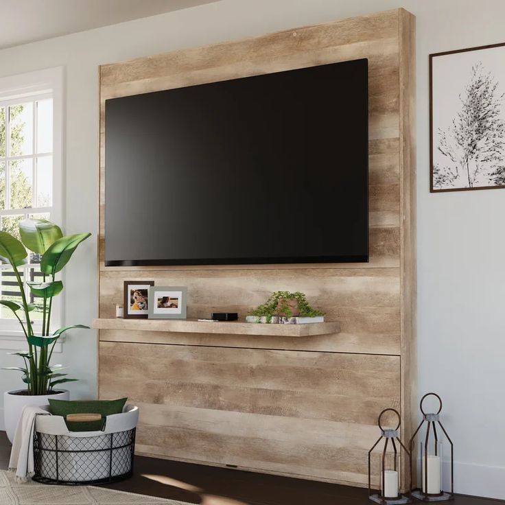 a flat screen tv mounted to the side of a wooden wall in a living room