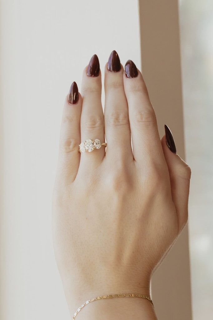 a woman's hand with two rings on it