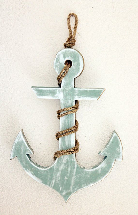 an anchor hanging from a rope on a wall