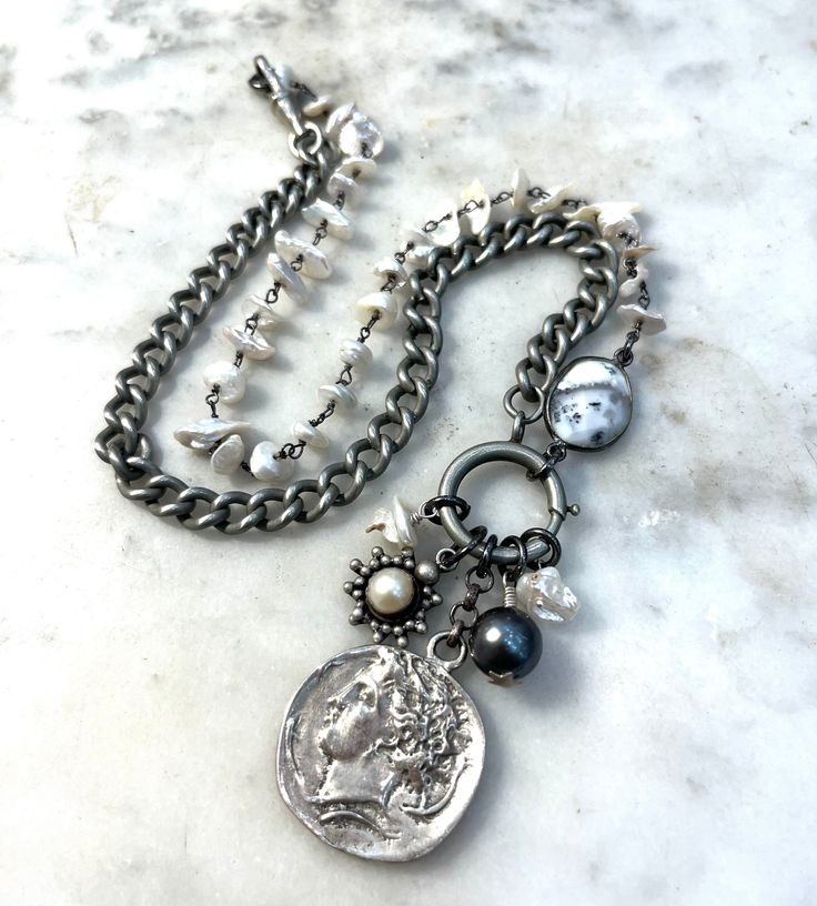 Vintage Roman coin necklace with Tahitian black pearl, white pearls, dendritic Opal, vintage pendant (silver plated), pocket watch chain (base metal) and sterling silver components.  The necklace is 20 inches long and the coin pendant is 1 inch round. Vintage Silver Jewelry With Pearl Charm, Timeless Silver Necklace With Pearl Chain, Vintage Silver Jewelry With Pearl Chain, Silver Medallion Jewelry With Pearl Chain, Timeless Silver Pendant Pearl Necklace, Silver Necklaces With Coin Pendant For Vintage Collection, Bohemian Silver Jewelry With Pearl Charm, Timeless Silver Pearl Pendant Necklace, Bohemian Silver Pearl Charm Necklace