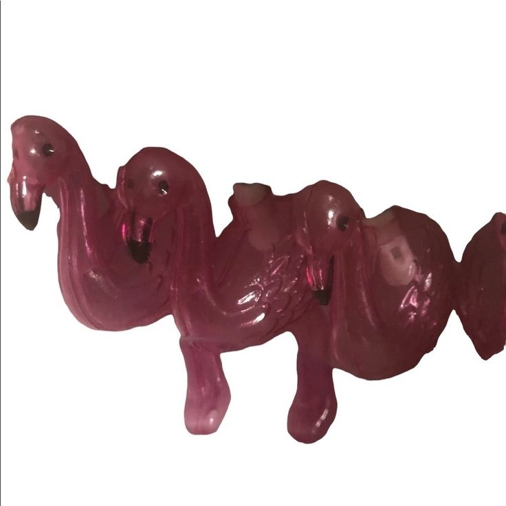 a pink plastic toy horse is shown on a white background and looks like it's coming out of the water