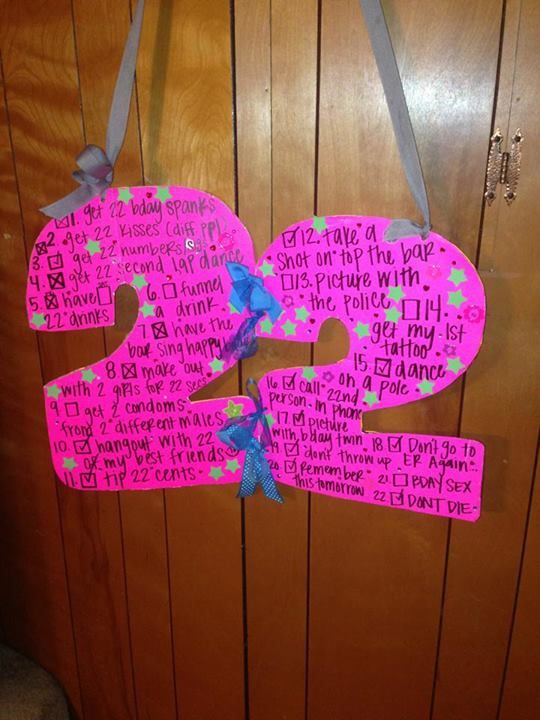 a pink door hanger with the number two on it and words written in different languages