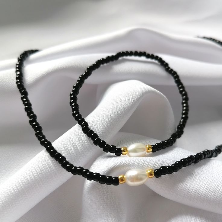 Black Round Beads Jewelry For Beach, Adjustable Black Pearl Beaded Bracelets, Black Minimalist Jewelry With Pearl Charm, Elegant Black Beads Beach Jewelry, Minimalist Black Jewelry With Pearl Charm, Elegant Beach Jewelry With Black Beads, Elegant Black Beads Jewelry For Beach, Black Beaded Necklaces With Pearl Charm Gift, Gift Black Beaded Necklaces With Pearl Charm