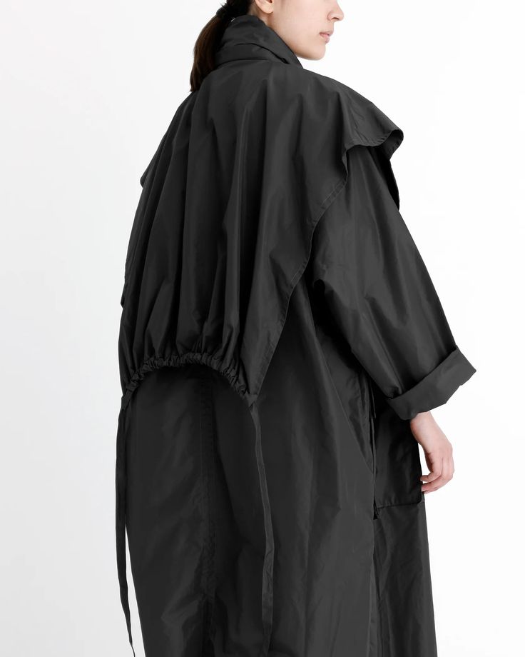 Packable Rain Trench - SS24 - Black – 7115 by Szeki Oversized Waterproof Spring Raincoat, Oversized Waterproof Raincoat For Spring, Modern Outerwear For Spring Rainy Weather, Black Raincoat With Detachable Hood For Spring, Black Spring Raincoat With Detachable Hood, Spring Black Raincoat With Detachable Hood, Black Fall Outerwear With Functional Drawstring, Black Outerwear With Functional Drawstring For Fall, Modern Hooded Raincoat For Spring