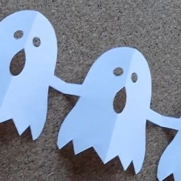 three paper ghost cut out on the ground