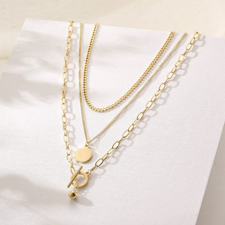 Stainless Steel | 316L. 14K Gold Plating. Hypoallergenic. Water Resistant. Gold Tarnish Resistant Chain Necklace, Gold Tarnish-resistant Chain Necklace, Gold Chain Necklace With Clavicle Chain, Elegant Gold Layered Necklace With Round Pendant, Elegant Gold Layered Round Necklace, Classic Gold Layered Necklace With Clavicle Chain, Minimalist Yellow Gold Layered Necklace, Tarnish Resistant, Minimalist Gold Jewelry With Double Chain, Minimalist Gold Double Chain Jewelry