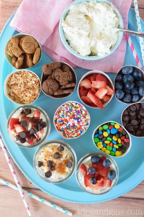 a blue plate topped with lots of desserts and ice cream covered in toppings