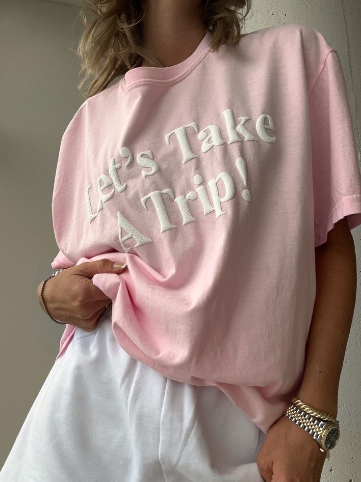 Introducing our newest addition to the travel inspired collection - the Let's Take a Trip Pink Tee! Made with a lightweight cotton blend for ultimate comfort, this tee features a stunning 3D white puff print graphic detailing that will make you stand out on your next adventure. Get ready to turn heads and inspire your next trip in style! Puff Print, Vintage Couture, Pink Tee, Travel Inspired, Print Graphic, Band Tees, Graphic Prints, Take A, Cotton Blend