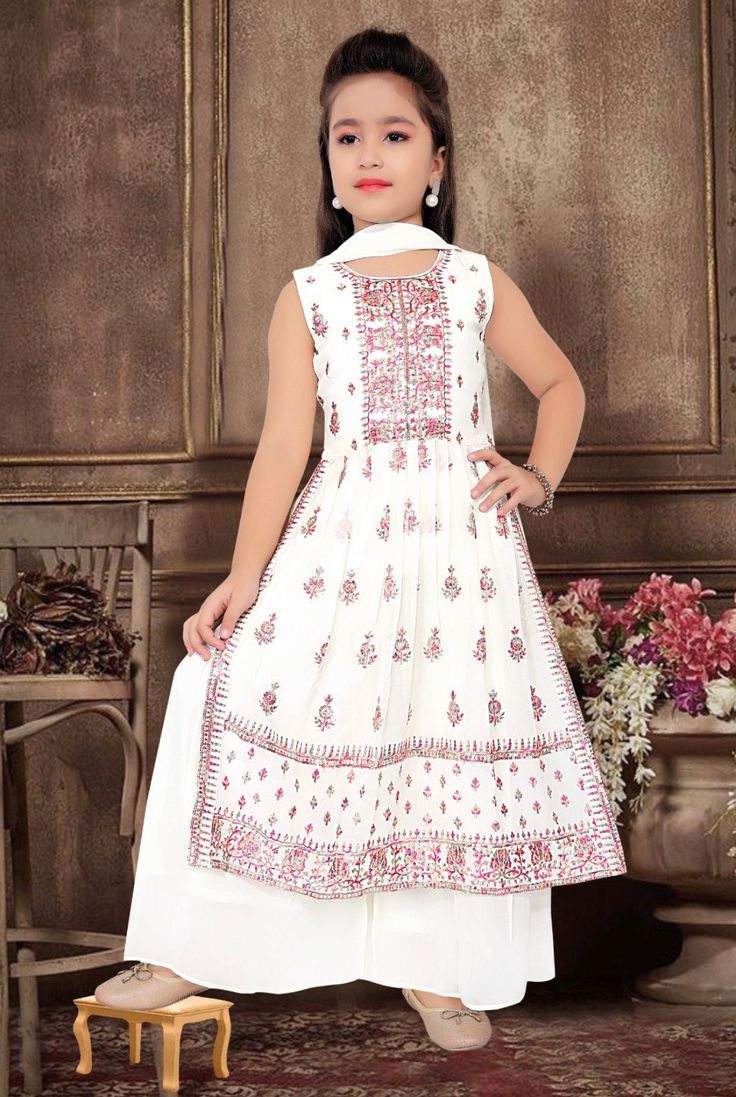 ABOUT THIS ITEM This girls Nyra Cut Sharara set with duppatta is suitable for kids 3-15 yrs age. Fabric Details: This is an exclusive Bollywood style party wear featuring excellent craftsmanship, beautiful embroidery, traditional prints, and vibrant colors.  The Sharara set is made with soft georgette fabric, light weight material with lining that is skin-friendly, breathable, and comfortable to wear for kids. Age Group: 3 - 15 years. For best fitting, please take measurements for your child and refer to the size chart in the last picture before purchase. Wash care Instructions: Do not bleach, Iron at low heat, and Dry Clean ( preferred for first wash). Occasion: Birthday gift, Festive wear, party/casual wear, wedding, and all special occasions. Package Includes: 1 Jacket +1 Blouse+1 shara Festive White Anarkali Set With Dabka, Festive White Lehenga With Dabka Detail, White Lehenga With Dabka For Festive Occasions, Fitted White Lehenga With Dabka Detail, Fitted White Lehenga With Dabka, White Self-design Choli For Navratri, White Cotton Sharara With Self Design, White Eid Choli With Self Design, White Self Design Choli For Diwali