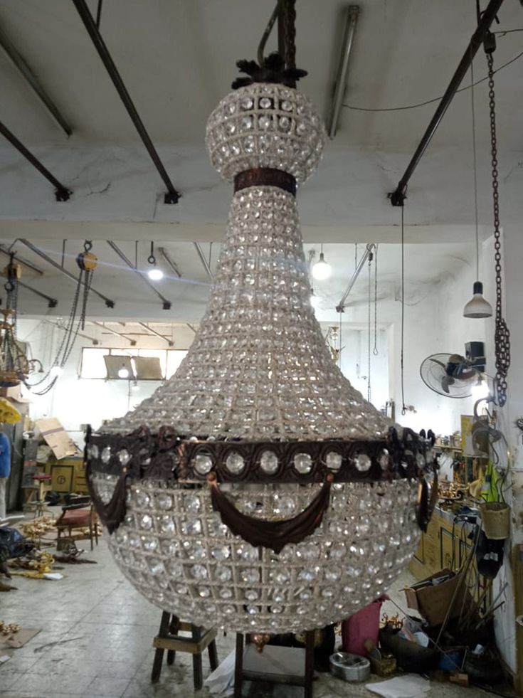 a large chandelier hanging from the ceiling in a room filled with other items