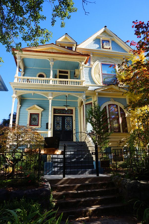 a blue house with white trim on the front door and steps leading up to it