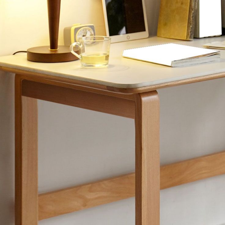 a desk with a lamp and some books on it