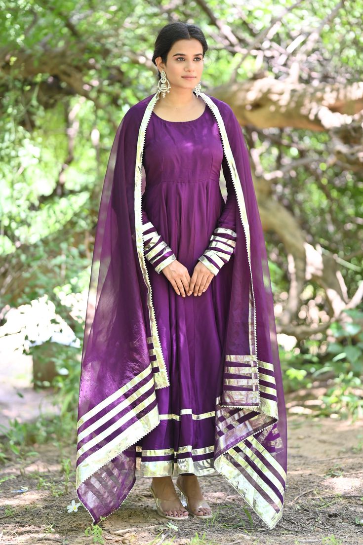 PRODUCT DESCRIPATION This festive season , be ready to impress! Shop it now and make Diwali memorable!Anarkali :- Upada silkPant :- CottonDupatta :- Organza silkClosure Used:- Side zipColor:- Deep purpleCare Instructions :- Dry clean onlyModel Size :- Model is wearing XS sizeModel Height :- 5.5'DISCLAIMER :- Slight color variations may occur due to different screen resolution. Maxi Length Chanderi Churidar With Dupatta, Silk Anarkali Set With Gota Work For Designer Wear, Silk Churidar With Sheer Dupatta For Navratri, Purple Silk Kurta With Gota Work, Festive Anarkali Silk Sharara, Art Silk Anarkali Set For Diwali, Silk Anarkali Set With Dupatta For Navratri, Anarkali Art Silk Set For Diwali, Festive Gota Work Maxi-length Dupatta