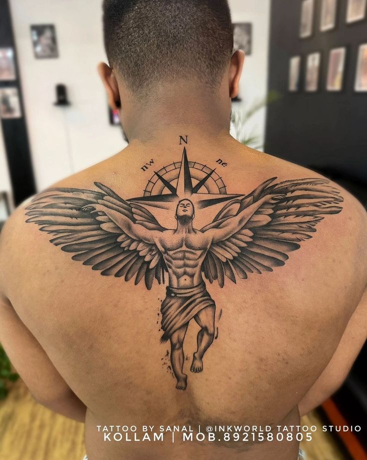 a man with a cross and wings tattoo on his back