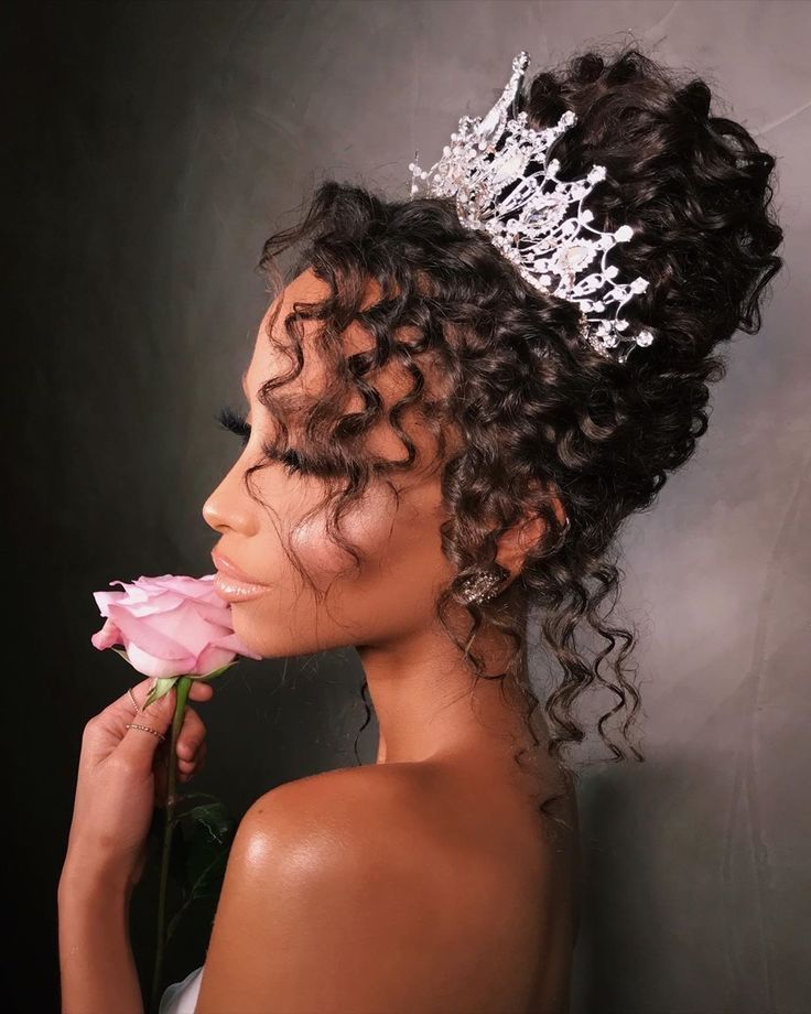 a woman wearing a tiara and holding a rose