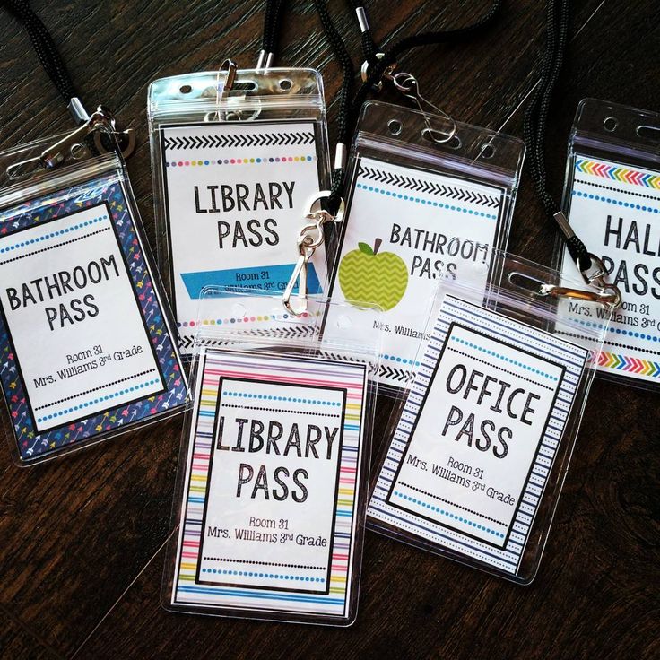 four library pass holders on a table with lanyards attached to each card holder