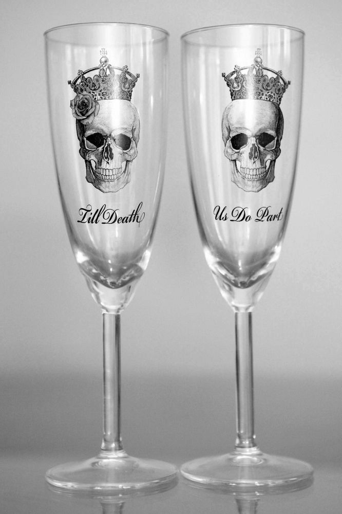 two wine glasses with skulls and crowns on them