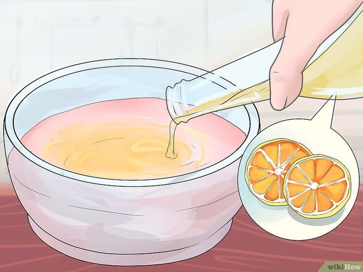 someone pouring orange juice into a bowl