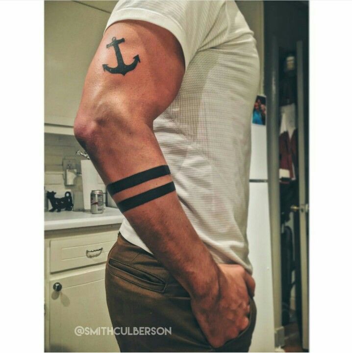 a man with a anchor tattoo on his arm