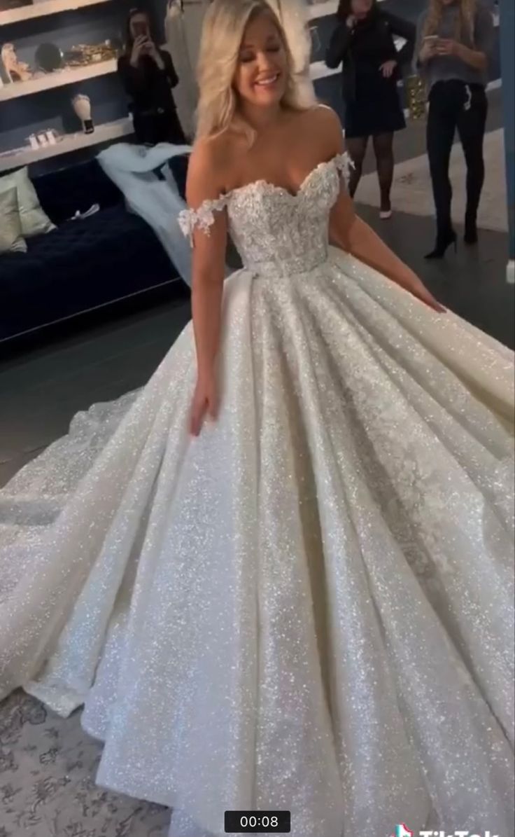 a woman in a white wedding dress posing for the camera