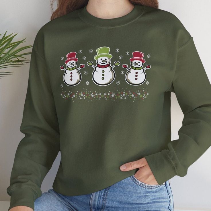 Christmas Snowman Sweater, Xmas Sweater, Christmas Jumper, Holiday Xmas Shirt, Christmas Crewneck, Snowmen Top, Xmas Jumper, Christmas Gift. Get ready to jingle all the way with our Festive Christmas Sweater! This isn't just any sweater, it's the ultimate Holiday Sweater that will have everyone at the party admiring your festive spirit. Whether you're decking the halls or just snuggling up by the fire, this Christmas Jumper is your go-to for spreading holiday cheer. Ideal for ugly sweater partie Green Festive Top For Winter, Festive Green Tops For Winter, Green Festive Tops For Winter, Green Christmas Sweater For Holidays, Green Christmas Sweater For Holiday Season, Green Winter Sweatshirt For Gift, Green Winter Sweatshirt For Gifts, Green Winter Sweatshirt Gift, Green Christmas Holiday Sweater