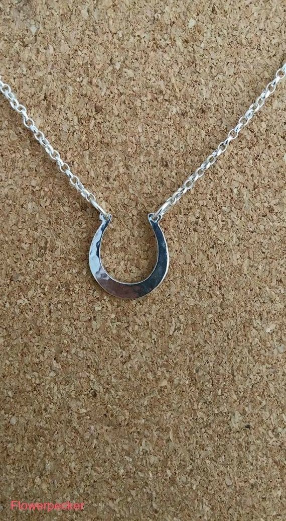 The horse silver pendant. Beautiful lucky horseshoe made in genuine 925 sterling silver.Lovely charm horseshoe ideal gift for wedding,bridesmaid gift or anyone who love horse. This silver charm can be personalized please do messages me. The horseshoe charm is 15 mm in size (1.5 cm) attached on 18 inches sterling silver chain. You will received the pendant in a gift boxed. Matching Earrings https://www.etsy.com/listing/211870097/horse-shoes-stud-earrings-lucky-horse?ref=shop_home_active_4 Fish Jewelry Silver, Precious Metal Clay Jewelry, Pumpkin Jewelry, Silver Pumpkins, Silver Flower Necklace, Horseshoe Necklace, Equestrian Jewelry, Horse Jewelry, Lucky Horseshoe