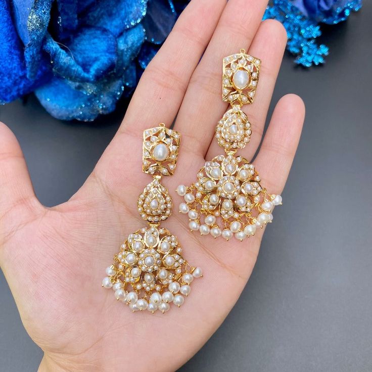 Featuring pearl earrings made in 22ct gold and set with freshwater pearls. The earrings weigh 23.43 GMs including 3.22 GMs in hanging beads