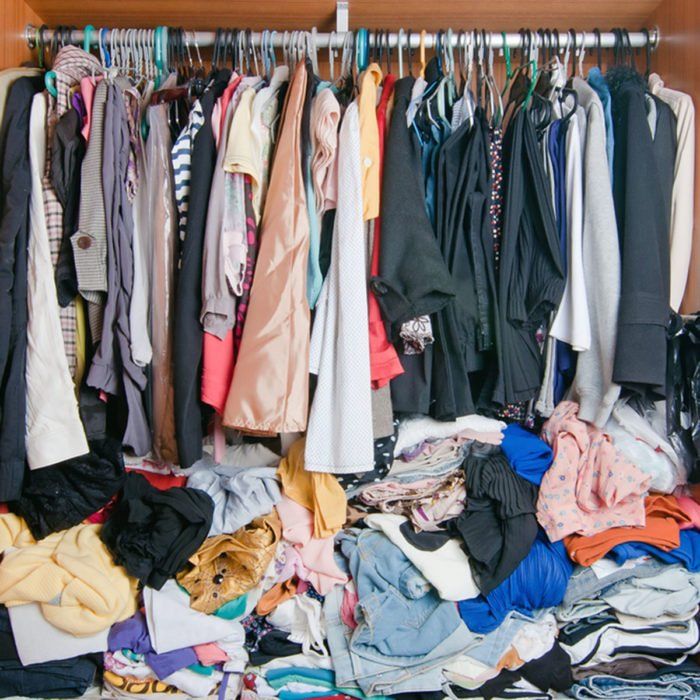 a closet filled with lots of different types of clothes