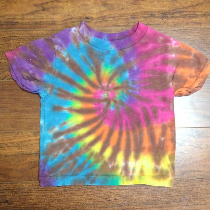 This dye was created on a size 2 100% Cotton Rabbit Skin tee. Hand Dyed Rainbow Tops For Spring, Hand Dyed Rainbow Top For Summer, Casual Rainbow Hand Dyed Tops, Rainbow Colored Hand Dyed Short Sleeve Tops, Casual Hand Dyed Rainbow Top, Rainbow Hand Dyed Short Sleeve Tops, Casual Hand-dyed Rainbow Top, Casual Rainbow Hand-dyed Top, Hand Dyed Rainbow T-shirt For Summer