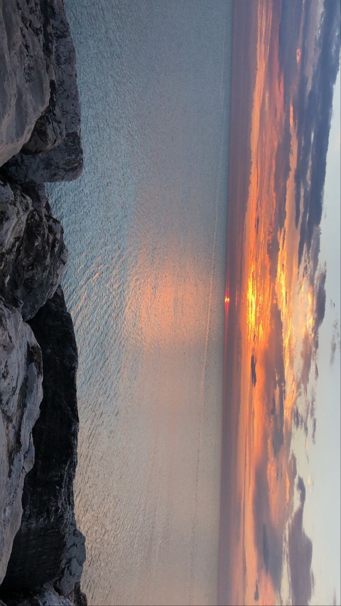 an aerial view of the ocean at sunset