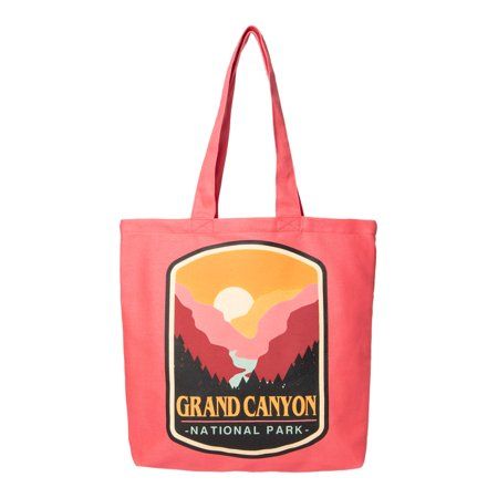 a pink tote bag with the grand canyon national park logo on it and mountains in the background