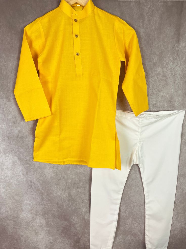 Soft Cotton Yellow Color Kurta with white cotton pajama. Perfect for Summers. Item : Boys Kurta Pajama Ready to Wear : Yes Kurta Color : Yellow Pajama Color : White Fabric : Cotton Lining : No Disclaimer - There can be little variation in the color due to screen resolution setting, phone display setting or anything else. Kindly do not hold us responsible. - No return or exchange will be accepted for color variations. - No return or exchange will be accepted if not matched with someone else Outfi Traditional Long Sleeve Cotton Pant Set, White Cotton Traditional Wear For Spring, White Long Sleeve Sets For Diwali, Traditional White Fitted Pant Set, White Long Sleeve Set For Diwali, Traditional Fitted White Pant Set, Traditional White Pant Set For Diwali, Traditional Cotton Wear For Summer, White Long Sleeve Sets For Festivals