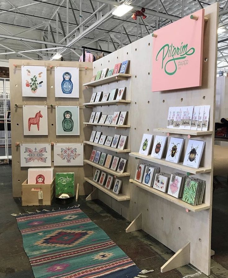 a room filled with lots of cards and pictures on the wall next to a rug