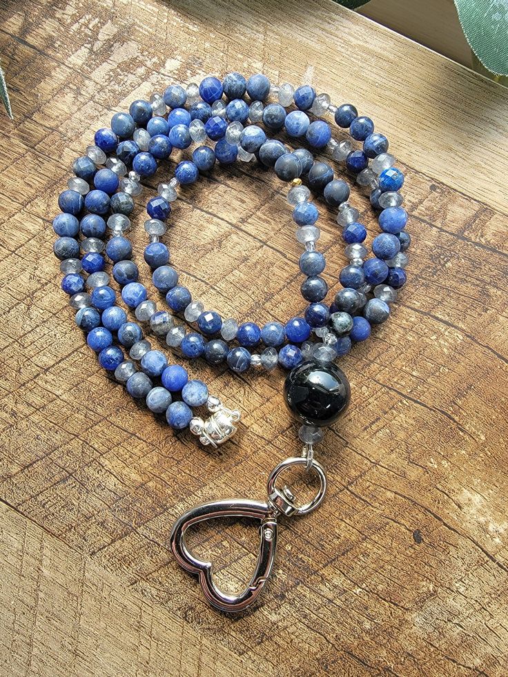 18" Beaded Lanyard features an AAA Black Agate focal bead, Sodalite, Jade and Czech glass beads with a heart shaped clasp.  🔮🔮 Each stone was selected for the ability to assist with Bonding, Trust, Manifestation and Awakening. 🔮🔮 🌼Lanyard has a Toggle clasp closure and lobster clasp for your keys and badge.  🌼  Your order will be carefully packaged to ensure that it gets you in excellent condition and I'll include a plastic badge holder and a freebies while my supplies last. 🌼  After your order is shipped (usually next day), I will send you the tracking number so you know when to expect your order. 🌼  Gemstones are known to hold many unique qualities. For more information on the healing powers of gemstones, take a look at my favorite website (not a paid promotion or affiliation,  I Trust Manifestation, Mystic Ct, Paid Promotion, Beaded Lanyard, Teacher Lanyard, Beaded Lanyards, Black Agate, Healing Powers, Badge Holder