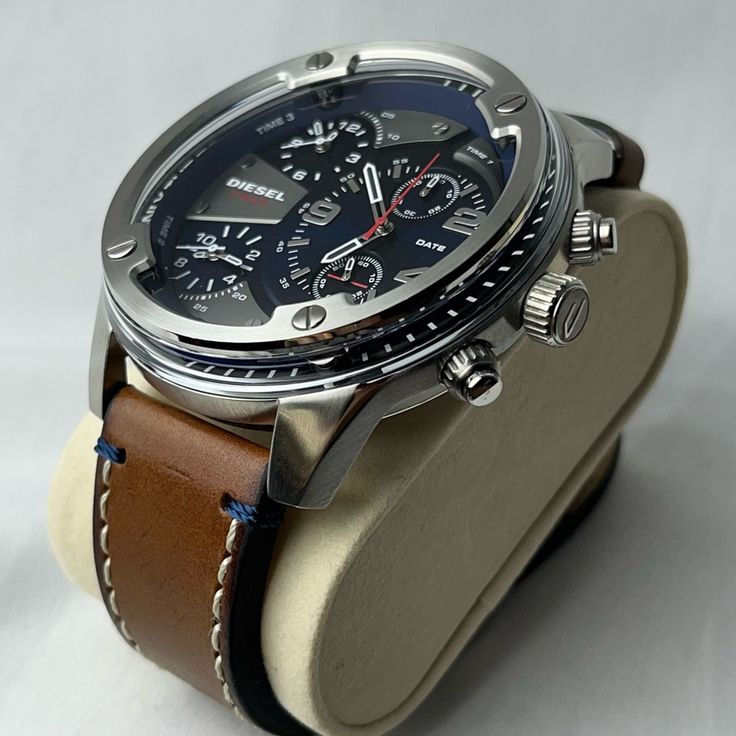 Dz7424 Man: Boltdown Three-Hand Brown Leather Watch | Diesel This Diesel Boltdown Watch Features A Blue Dial And Two Sub Dials With White Stick Indexes And Numerals, Three-Hand Movement And Brown Leather Strap. Case Size: 56 Mm Case Thickness: 12 Mm Water Resistance: 3 Atm Case Material: Stainless Steel Case Finish: Combo Attachment Material: Leather Attachment Color: Brown Closure/Adjustability: Single Prong Strap Buckle Dial Color: Blue Movement: Quartz/3 Hand Like New Without Tags Needs New B Designer Leather Chronograph Watch Analog, Casual Silver Watches With Subdials, Luxury Silver Chronograph Watch With Leather Strap, Business Silver Leather Watch Bands, Casual Silver Chronograph Watch With Round Dial, Designer Leather Chronograph Watch Accessories, Designer Leather Watch With Tachymeter, Designer Analog Leather Watch Accessories, Designer Leather Watches With Subdials