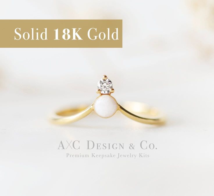 a gold ring with a white pearl on it and the words sold 18k gold