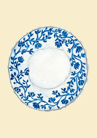 a blue and white plate sitting on top of a table next to a yellow wall