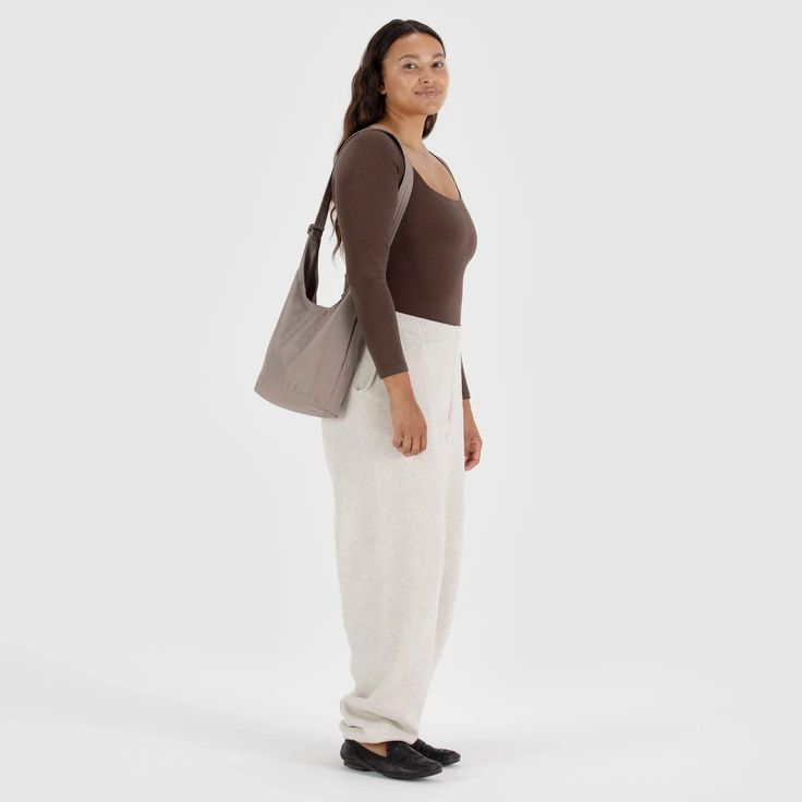 A slouchy, softly structured nylon bag with an adjustable strap. Interior zip pocket with a magnetic closure. Heavyweight nylon (59% recycled)9.5"H × 7"W × 4.25"D 39" adjustable strapMachine washable Casual Nylon Hobo Bag For On-the-go, Casual Nylon Crossbody Hobo Bag, Casual Hobo Bag With Double Handle For On-the-go, Casual Tote Baguette Bag For On-the-go, Versatile Bag With Soft Interior, Versatile Everyday Bag With Soft Interior, Casual Nylon Softback Shoulder Bag, Casual Softback Nylon Shoulder Bag, Casual Nylon Hobo Bag With Removable Pouch