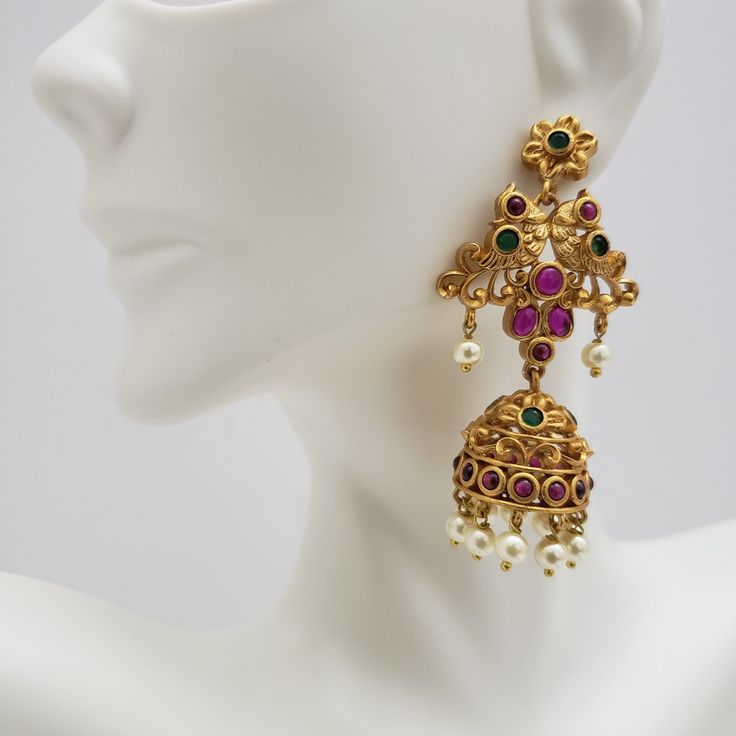 "This beautiful earrings set has an excellent finish and gives out an exquisite sense of style. If you are looking for an amazing Fashion Jewelry set for special occasions such as Anniversary, Engagement, Party, Wedding, or for gifting, then your search ends here. Handmade Indian Temple Jewelry, best to wear it for traditional ceremonies or Indian wedding. This bridal jewelry has an ethnic finish. It has Cubic Zircon stones with semi-precious ruby and emeralds. It is a Bollywood style one gram j Elegant Jhumkas For Diwali Festival, Elegant Jhumkas For Diwali Festivities, Temple Jewelry Pearl Earrings With Latkans For Celebration, Gold Temple Jewelry Pearl Earrings For Celebration, Traditional Gold-plated Pearl Earrings With Intricate Design, Wedding Chandbali Jhumkas With Elegant Design, Elegant Chandbali Jhumkas For Wedding, Bollywood Style Yellow Gold Wedding Danglers, Gold Peacock Design Jewelry Sets For Weddings