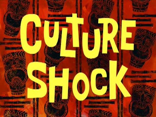 the words culture shock written in yellow and black on a red background with african masks