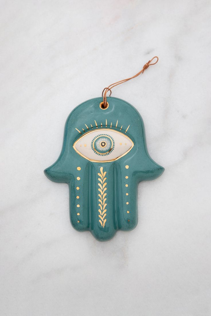 a ceramic hamsa with an eye on it